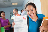 Happy Female Student in Class With Great Test Grade