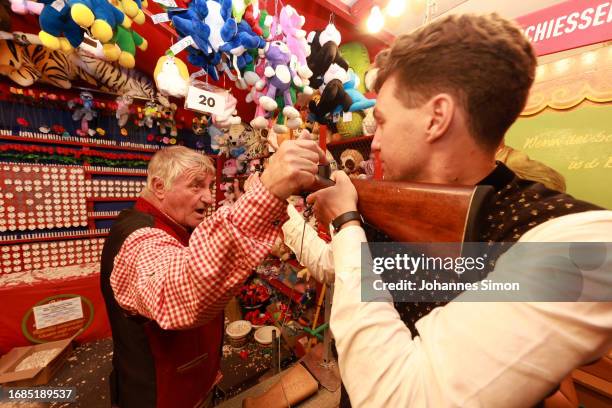 People take part in fun fair games on the opening day of the 2023 Munich Oktoberfest on September 16, 2023 in Munich, Germany. This year's...