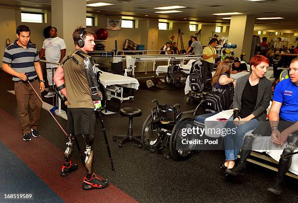 Soldiers exercise in the physiotherapy gym room visited by Prince Harry during his visit to the Military Advanced Training Center at Walter Reed...