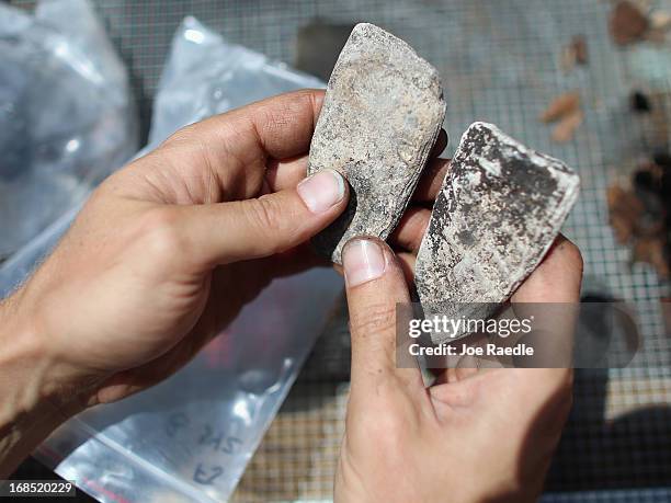 Archaeologist Dr. Ryan Franklin, with the Archaeological and Historical Conservancy, holds axes made more than 1,000 years ago from shells during an...