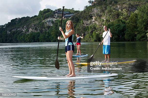 youg adults paddleboarding stand up paddling - paddle boarding bildbanksfoton och bilder