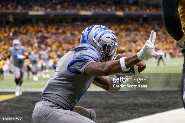 Wide receiver Joseph Scates of the Memphis Tigers reacts after scoring a touchdown during the first half against the Missouri Tigers at The Dome at...