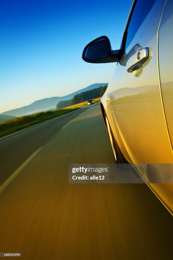 Closeup of a car driving on a road