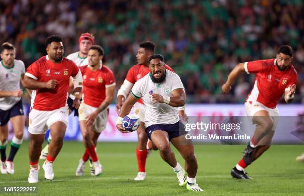 Bundee Aki of Ireland breaks with the ball to score his team's sixth try during the Rugby World Cup France 2023 match between Ireland and Tonga at...