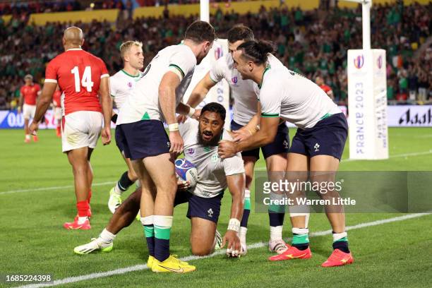 Bundee Aki of Ireland celebrates with teammates after scoring his team's sixth try during the Rugby World Cup France 2023 match between Ireland and...