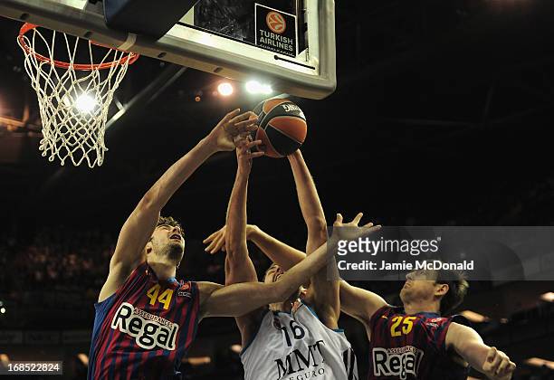 Mirza Begic of Real Madrid tussles with Ante Tomic and Erazem Lorbek of FC Barcelona shoots a basket during the Turkish Airlines EuroLeague Final...
