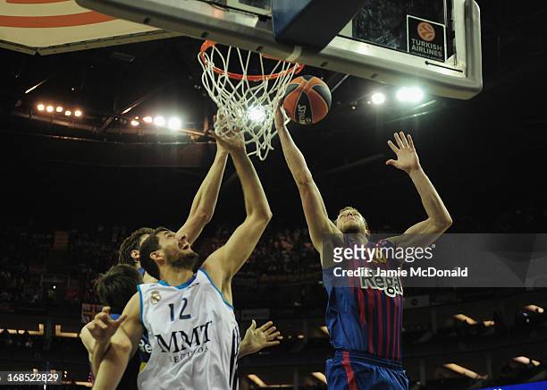 Nikola Mirotic of Real Madrid tussles with Joe Ingles of FC Barcelona during the Turkish Airlines EuroLeague Final Four semi final game between FC...