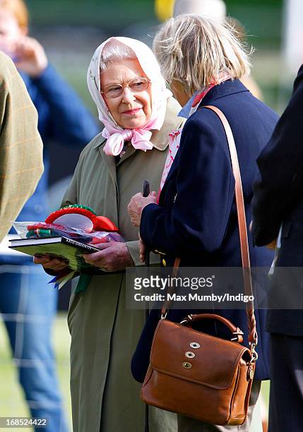 Queen Elizabeth II holds her rosettes after her horse Barbers Shop won the Tattersalls & Ror Thoroughbred Ridden Show Horse Class on day 3 of the...