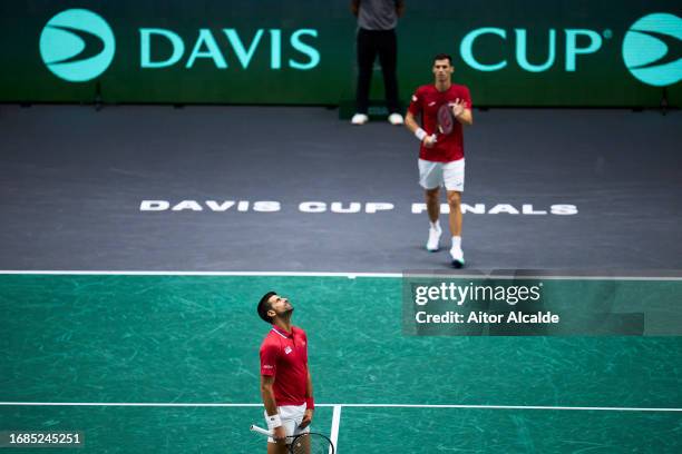 Novak Djokovic and Nikola Cacic of Serbia reacts after missing a point celebrates against Adam Pavlasek and Tomas Machac of Czechia during the match...