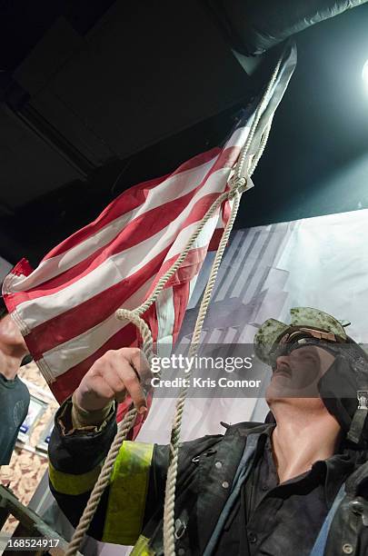 Wax figures of New York City firefighters raising the flag at ground zero are displayed during the Madame Tussauds "HOPE: Humanity And Heroism" 9/11...