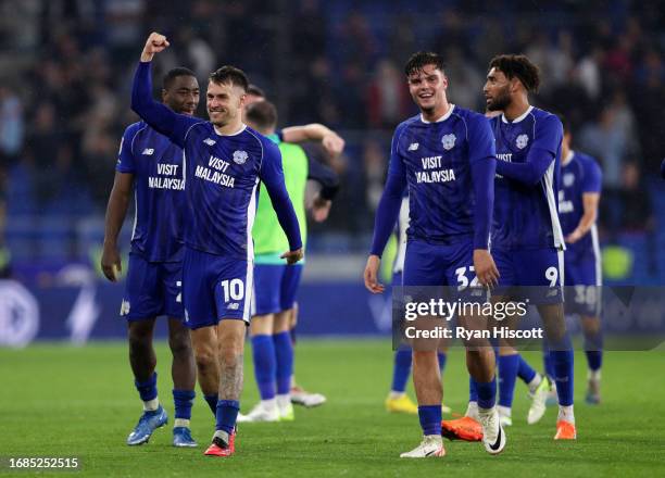 Aaron Ramsey of Cardiff City celebrates victory with teammate Ollie Tanner after defeating Swansea City during the Sky Bet Championship match between...