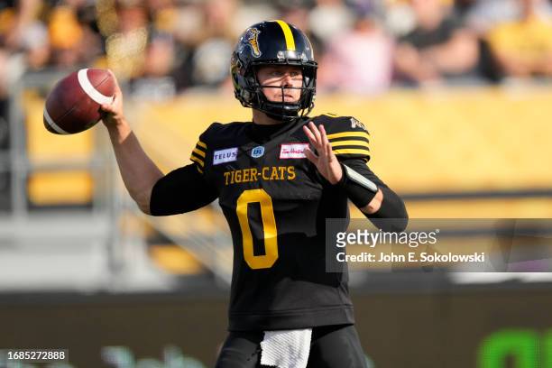 Taylor Powell of the Hamilton Tiger-Cats goes to throw a pass against the Winnipeg Blue Bombers during the first half at Tim Hortons Field on...
