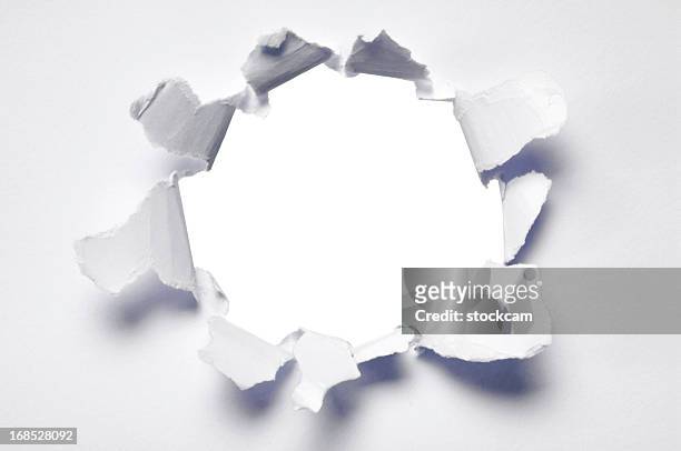 ripped hole in blank paper - punching stock pictures, royalty-free photos & images