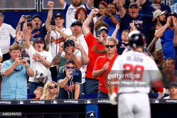 Fans react after Matt Olson of the Atlanta Braves hits a home run against the Miami Marlins for his 52nd home run of the season during the sixth...