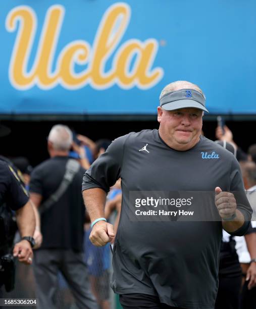 Head coach Chip Kelly of the UCLA Bruins runs on to the field before the game against the North Carolina Central Eagles at Rose Bowl Stadium on...