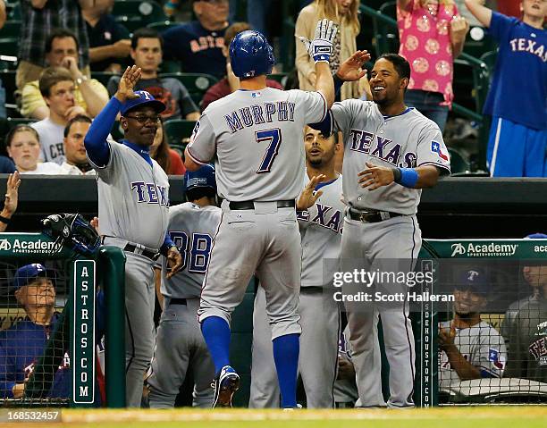 Manager Ron Washington, David Murphy and Elvis Andrus of the Texas Rangers celebrate at the dugout after Murphy hit a solo home run in the ninth...