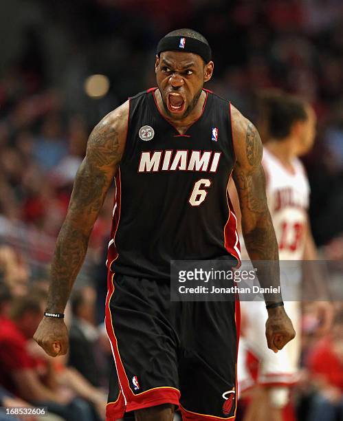 LeBron James of the Miami Heat reacts after hitting a three point shot in the 4th quarter against the Chicago Bulls in Game Three of the Eastern...