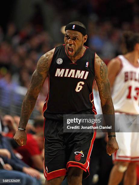 LeBron James of the Miami Heat reacts after hitting a three point shot in the 4th quarter against the Chicago Bulls in Game Three of the Eastern...