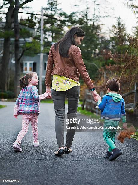 mother and children walking - alexandra walker stock pictures, royalty-free photos & images