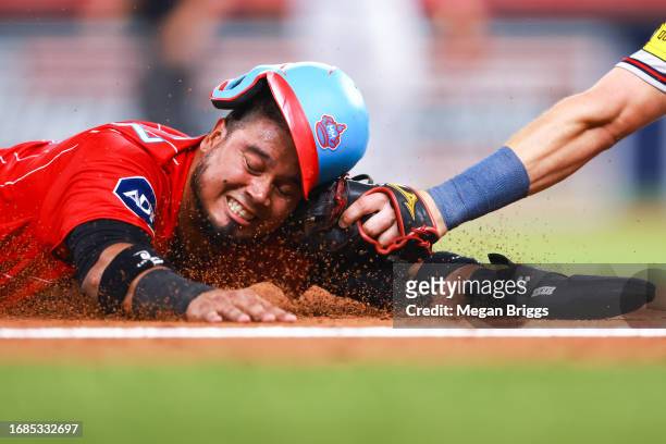 Austin Riley of the Atlanta Braves tags out Luis Arraez of the Miami Marlins at third base during the sixth inning of the game at loanDepot park on...