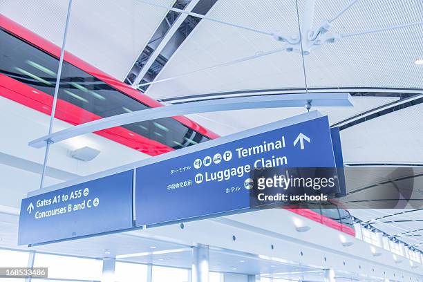 modern airport tram and signs - information symbol stockfoto's en -beelden