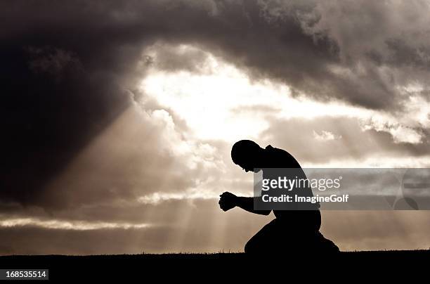 middle aged man prayer silhouette - healing prayer images stock pictures, royalty-free photos & images