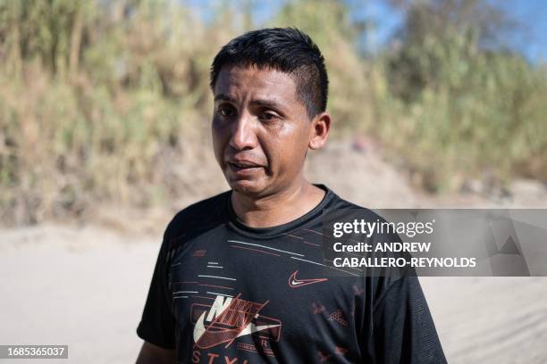 Victor Manuel Atencio from Venezuela, cries as he speaks to AFP after crossing the US-Mexico border in Eagle Pass, Texas on September 23, 2023.