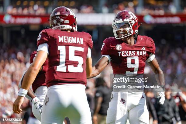 Jahdae Walker of the Texas A&M Aggies makes a reception for a touchdown and celebrates with Conner Weigman during the first half against the...