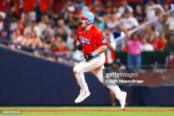 Jake Burger of the Miami Marlins reacts after hitting a home run against the Atlanta Braves during the eighth inning of the game at loanDepot park on...