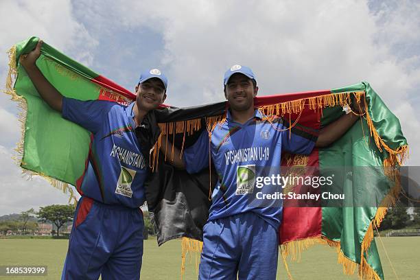 Sayed Ahmad Shirzad and Zia Ur Rehman Akbar of Afghanistan celebrate after their team defeated United Arab Emirates during the 2013 Asian Cricket...