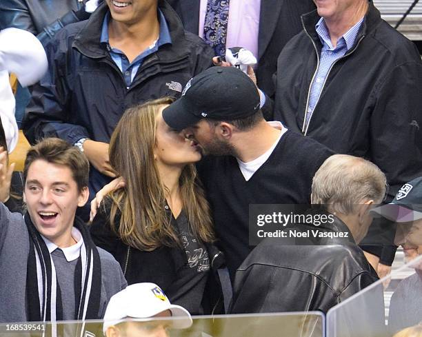 Alyssa Milano and husband David Bugliari kiss at the conclusion of an NHL playoff game between the St. Louis Blues and the Los Angeles Kings at...