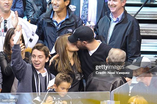 Alyssa Milano and husband David Bugliari kiss at the conclusion of an NHL playoff game between the St. Louis Blues and the Los Angeles Kings at...