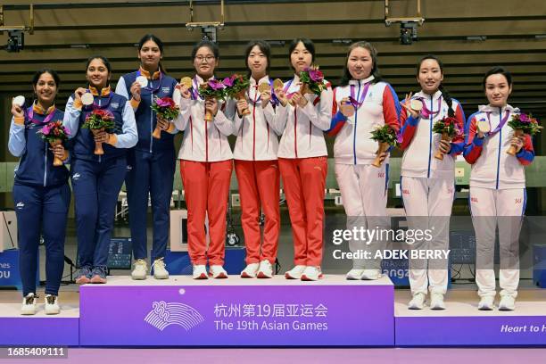 Gold medallists China's Han Jiayu, Huang Yuting, Wang Zhilin; silver medallists India's Ramita, Ashi Chouksey, Mehuli Ghosh; bronze medallists...