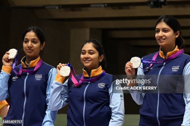 Silver medallists India's Ramita, Ashi Chouksey, Mehuli Ghosh pose on the podium during the medal ceremony for the women's team 10m air rifle...