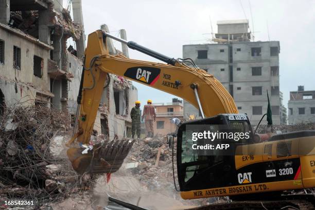 Bangladesh Army personnel continue the second phase of the rescue operation using heavy equipment after an eight-storey building collapsed in Savar,...