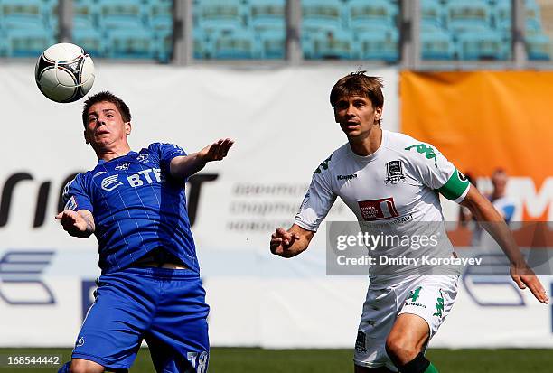 Pavel Solomatin of FC Dynamo Moscow is challenged by Alyaksandr Martynovich of FC Krasnodar during the Russian Premier League match between FC Dynamo...