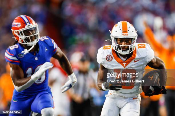 Squirrel White of the Tennessee Volunteers catches a pass against Miguel Mitchell of the Florida Gators during the first quarter of a game at Ben...