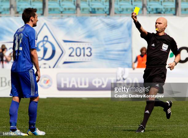 Referee Sergey Karasev shows a yellow card to Marko Lomic of FC Dynamo Moscow during the Russian Premier League match between FC Dynamo Moscow and FC...