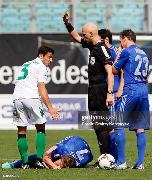 Referee Sergey Karasev shows a yellow card to Dusan Andelkovic of FC Krasnodar during the Russian Premier League match between FC Dynamo Moscow and...