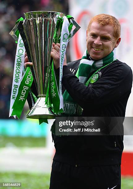 Celtic Manager Neil Lennon poses with the Scottish Premier League trophy following the Clydesdale Bank Scottish Premier League match between Celtic...