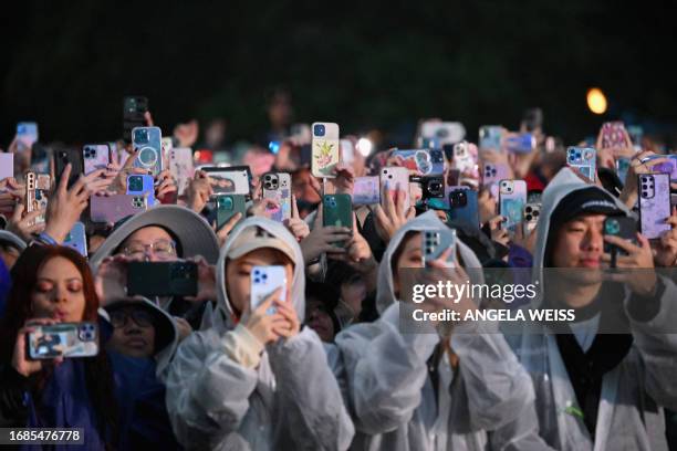 Fans record with their phones as South Korean singer Jungkook performs onstage during the Global Citizen Festival at Central Park in New York City on...