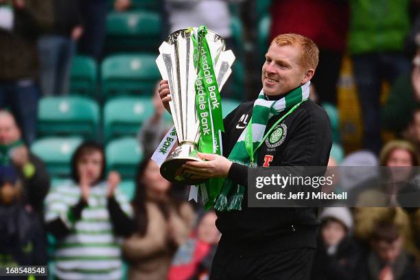 Celtic Manager Neil Lennon poses with the Scottish Premier League trophy following the Clydesdale Bank Scottish Premier League match between Celtic...