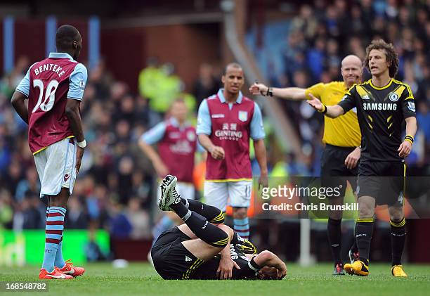 John Terry of Chelsea lies injured after being fouled by Christian Benteke of Aston Villa , who is then sent-off by referee Lee Mason during the...