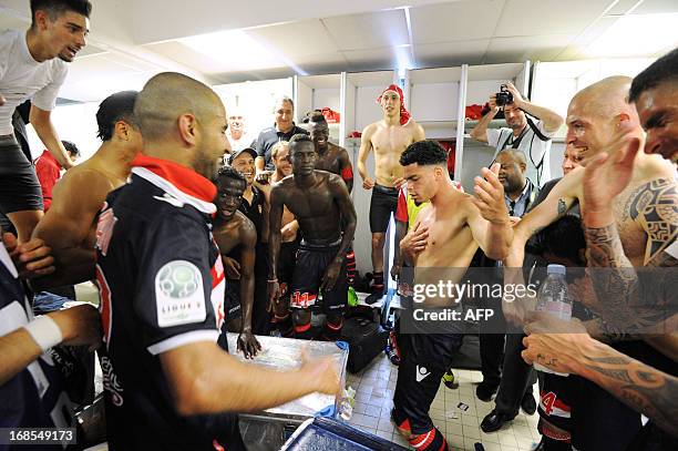 Monaco's players celebrate on May 11, 2013 at the end of the French L2 football match Nimes vs Monaco at the Costieres stadium in the southern French...