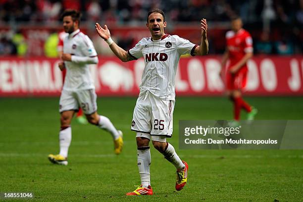 Javier Horacio Pinola of FC Nuernberg celebrates in front of his teams fans after a goal scored during the Bundesliga match between Fortuna...