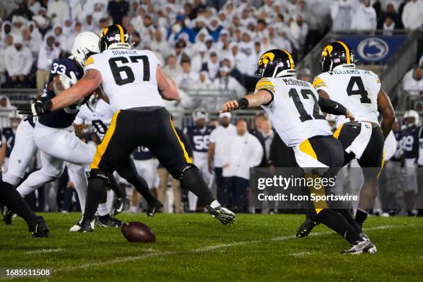 Iowa Hawkeyes Quarterback Cade McNamara fumbles the ball during the second half of the College Football game between the Iowa Hawkeyes and Penn State...