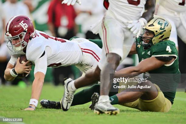 Ty Simpson of the Alabama Crimson Tide in sacked by Jason Vaughn of the South Florida Bulls in the third quarter at Raymond James Stadium on...