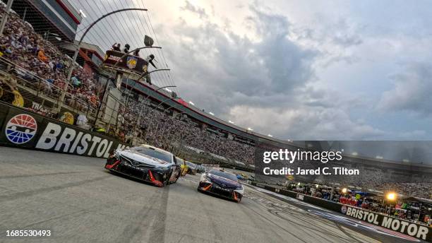 Christopher Bell, driver of the Reser's Fine Foods Toyota, and Denny Hamlin, driver of the FedEx Freight Direct Toyota, lead the field on a pace lap...