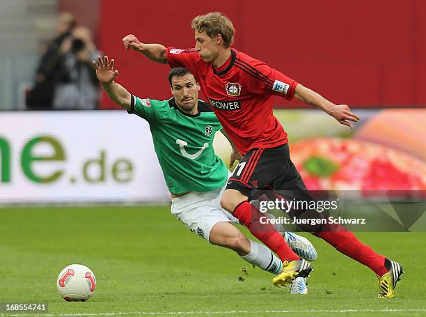 Stefan Kiessling of Leverkusen tackles Mario Eggimann of Hannover during the Bundesliga match between Bayer 04 Leverkusen and Hannover 96 at BayArena...