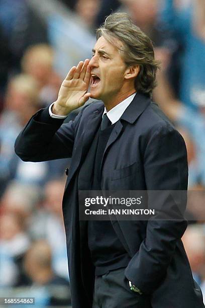 Manchester City's Italian manager Roberto Mancini shouts from the touchline at the start of the English FA Cup final football match between...